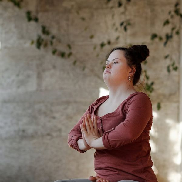 Person holding a difficult balancing yoga pose.