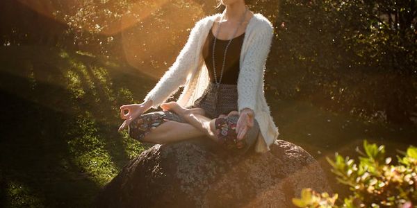 Person sitting peacefully in a meditation pose.